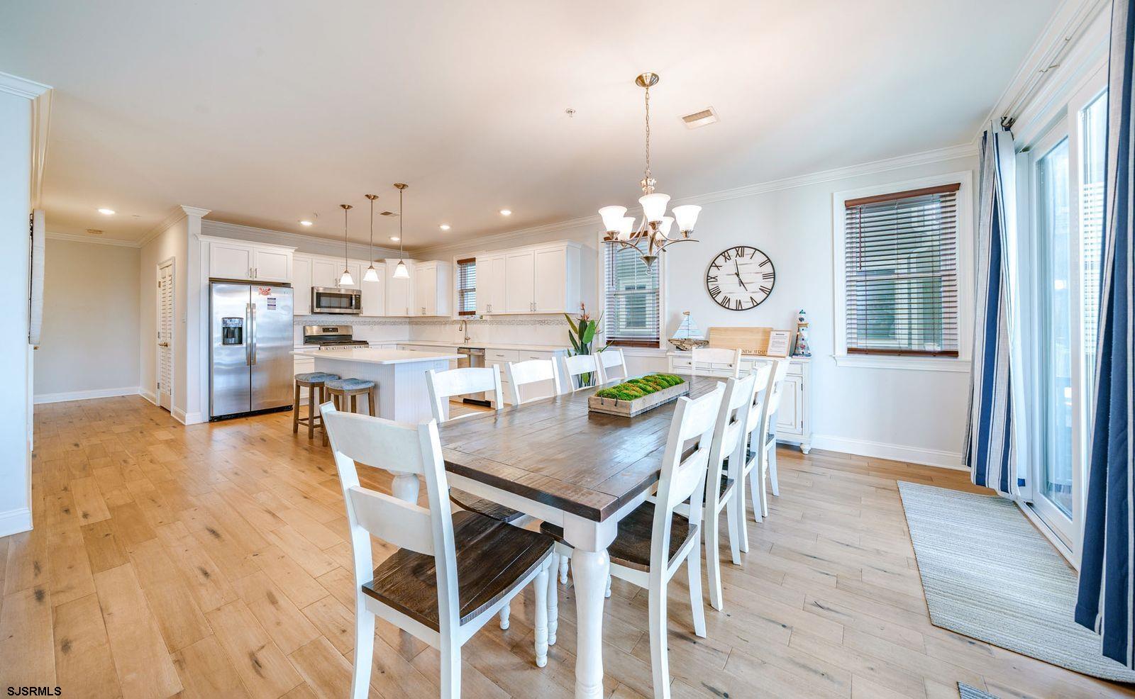 901 Wesley Avenue, Unit B Ocean City, NJ 08226 - Photo 6 of 33 a view of a dining room and livingroom with furniture wooden floor a chandelier