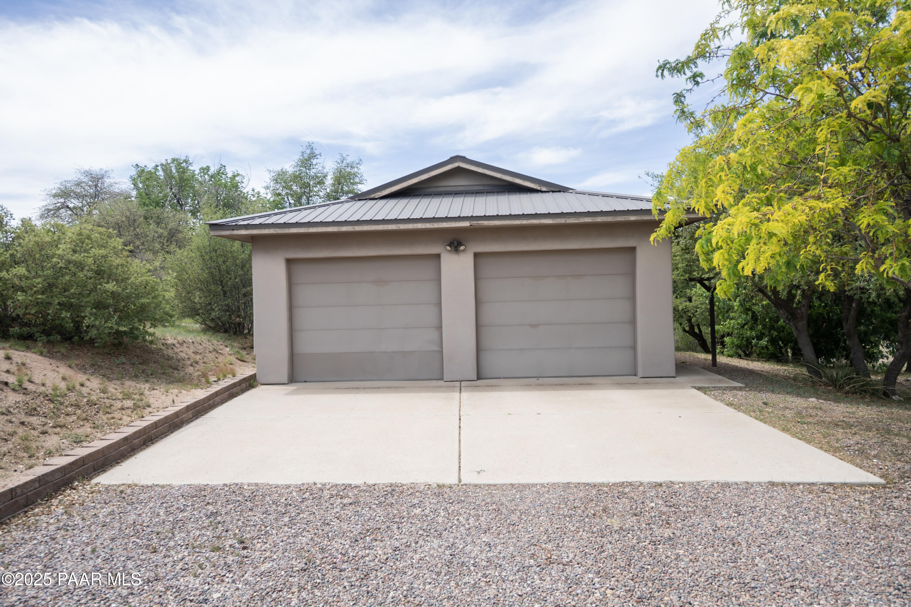 770 Grisby Road Skull Valley, AZ 86338 - Photo 34 of 58 a front view of a house with a yard and garage