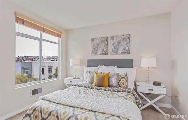 a bedroom with a large bed and a window