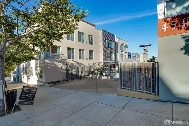 a row of table and chairs with wooden fence