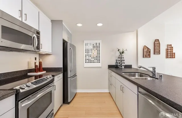 a kitchen that has a sink and a stove