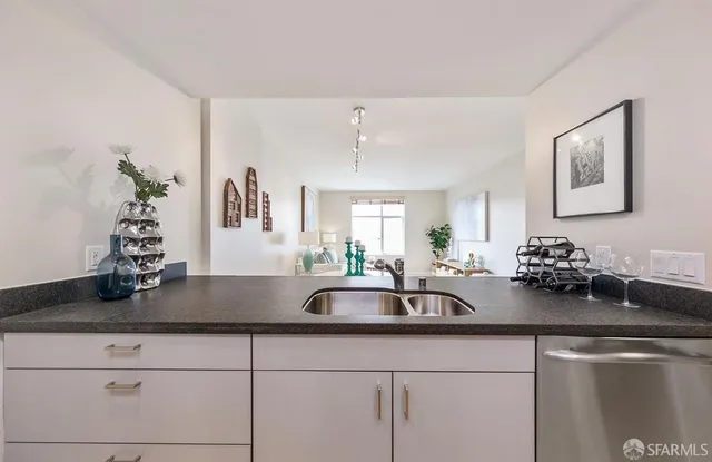 a kitchen with sink and flowers