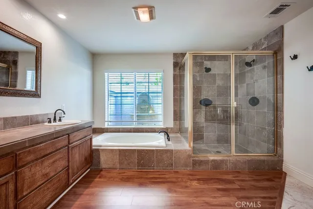 a bathroom with a tub sink and mirror