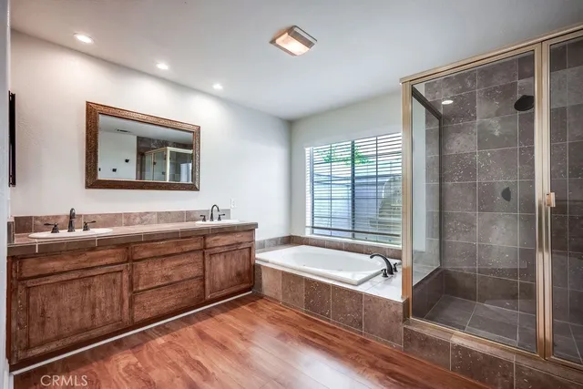 a bathroom with a bathtub sink and mirror