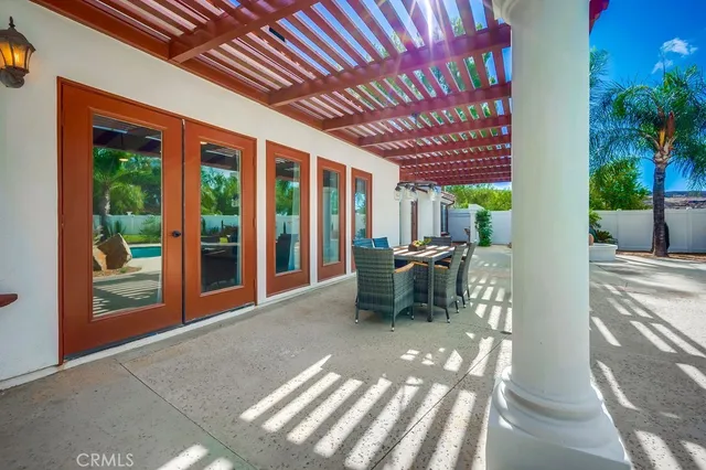 a view of a patio with table and chairs and potted plants
