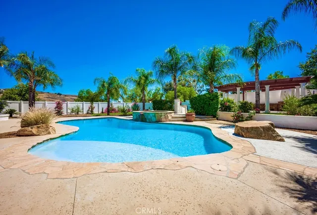 a view of swimming pool with outdoor seating and a patio