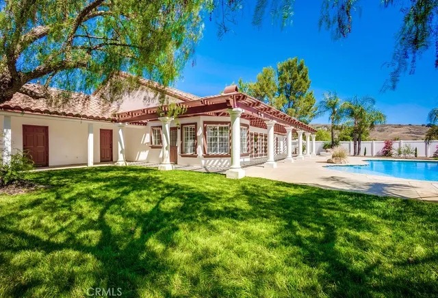 a front view of a house with a garden and yard