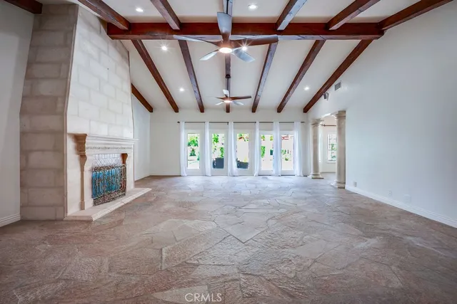 a view of a livingroom with an empty space and a fireplace