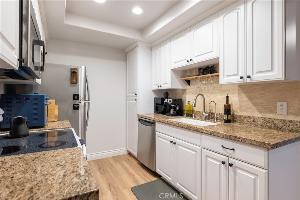 20702 El Toro Road, Unit 178 Lake Forest, CA 92630 - Photo 8 of 30 a kitchen with stainless steel appliances granite countertop a sink stove and cabinets