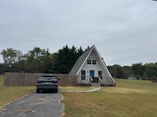 a view of a house with swimming pool and sitting area