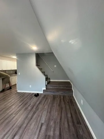 a view of entryway and hall with wooden floor