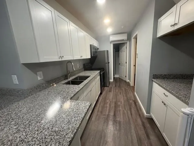 a kitchen with granite countertop lots of counter top space and stainless steel appliances