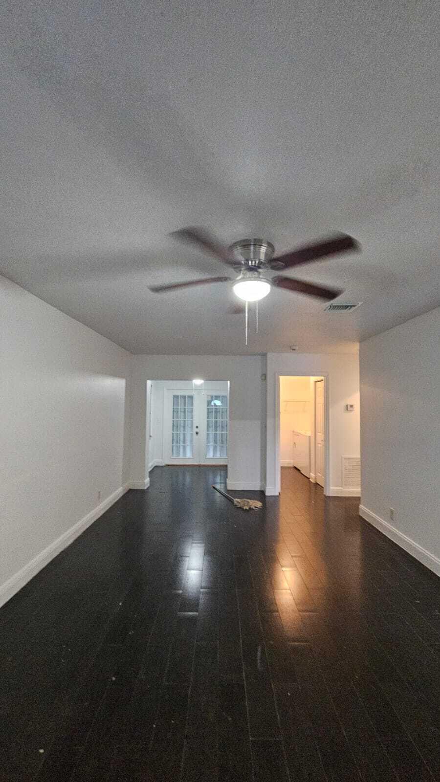 3391 Avenue South Riviera Beach, FL 33404 - Photo 6 of 16 an empty room with wooden floor and windows