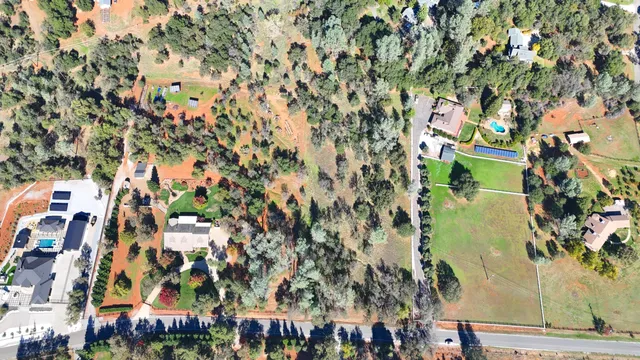 an aerial view of residential houses with city view