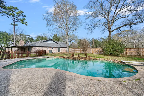a view of a house with pool and a yard