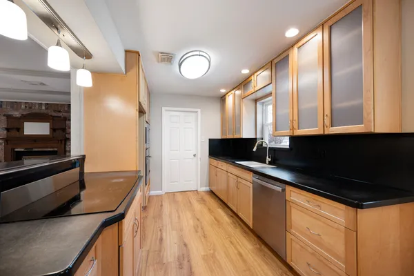 a kitchen with stainless steel appliances granite countertop a stove and a sink