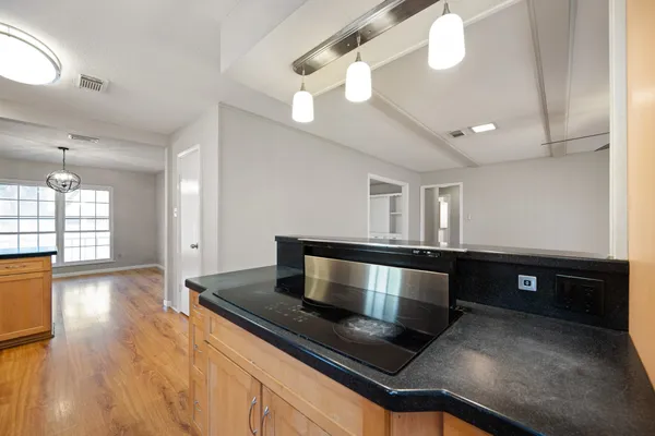 a large kitchen with stainless steel appliances a large counter top