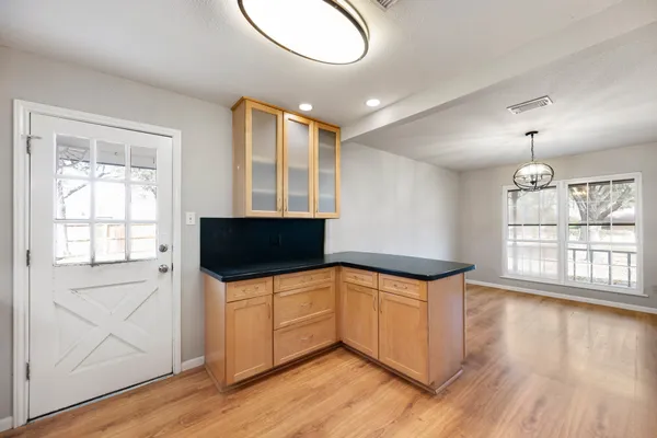 a kitchen with stainless steel appliances granite countertop a sink a microwave cabinets and wooden floor