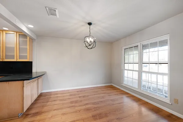 a very nice looking room with wooden floor and a window