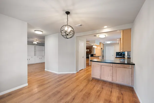 a view of a kitchen counter space a sink and wooden floor