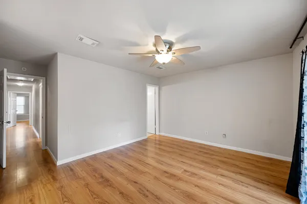 wooden floor in an empty room with a window