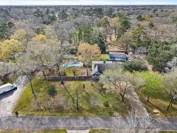 an aerial view of a house with a yard basket ball court