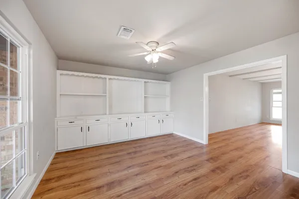 wooden floor in an empty room with a window