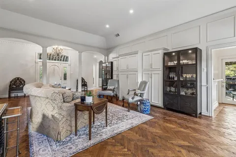 a living room with furniture and a chandelier