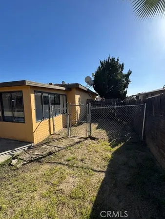 a view of house with backyard and sitting area