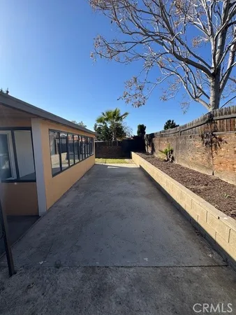 a view of a porch with furniture and a yard