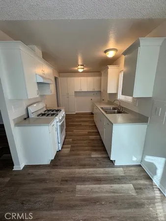 a kitchen with stainless steel appliances granite countertop a stove and a sink