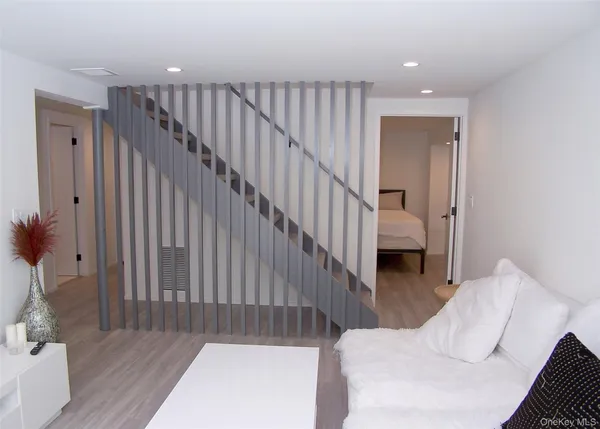 a view of staircase with wooden floor and a rug