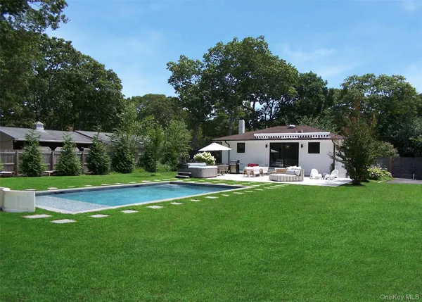 a front view of house with yard and outdoor seating