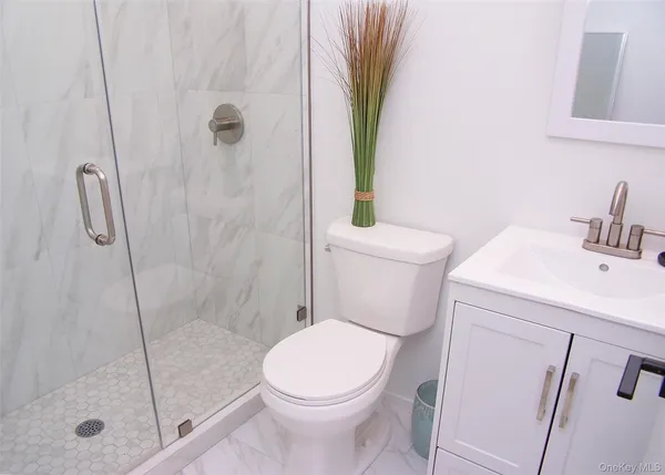 a white toilet sitting next to a bath tub