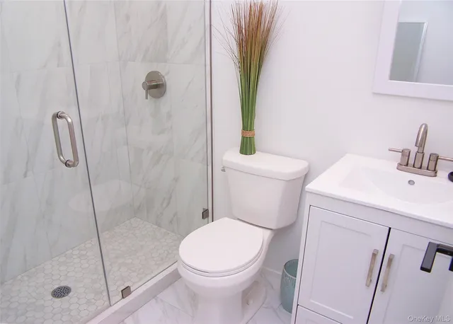 a white toilet sitting next to a bath tub
