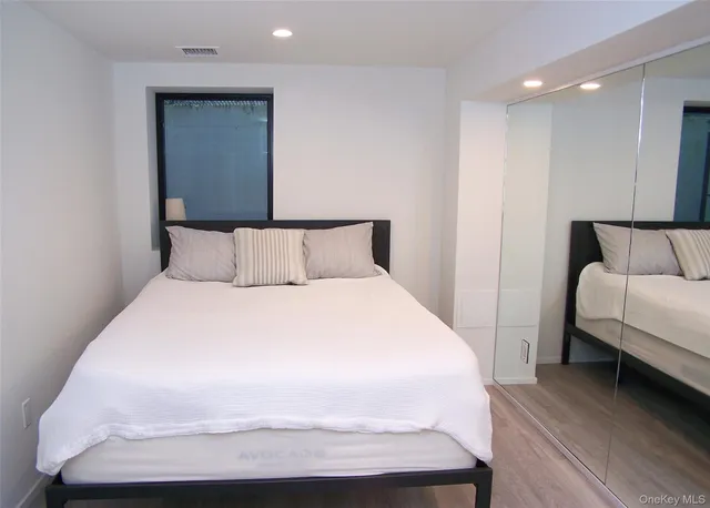 a bedroom with a bed and a night stand