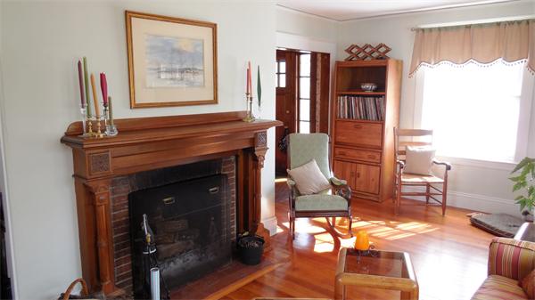 85-81 Hillside Road Wellesley, MA 02481 - Photo 3 of 24 a living room with furniture a flat screen tv and a fireplace