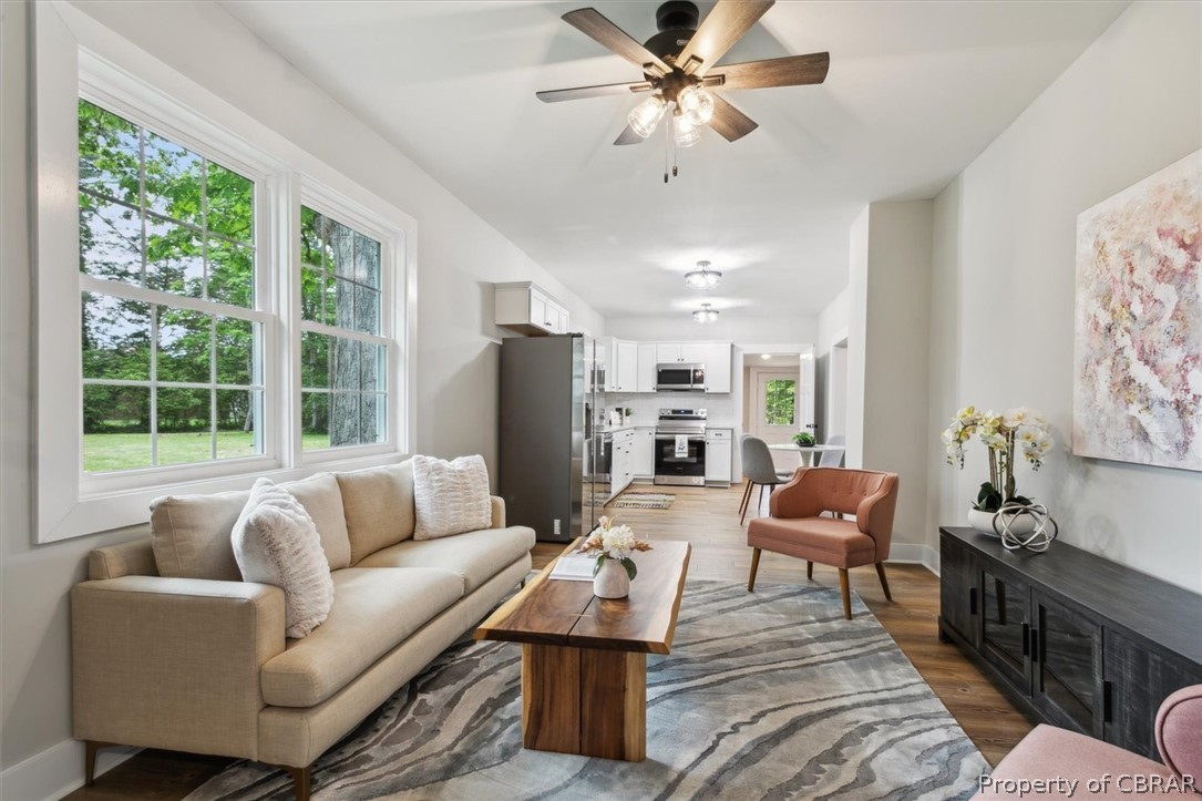 8213 Croaker Road Williamsburg, VA 23188 - Photo 19 of 50 Living room with dark hardwood / wood-style flooring and ceiling fan