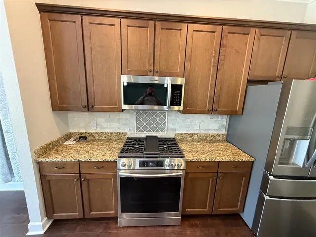 a kitchen with a stove microwave and sink