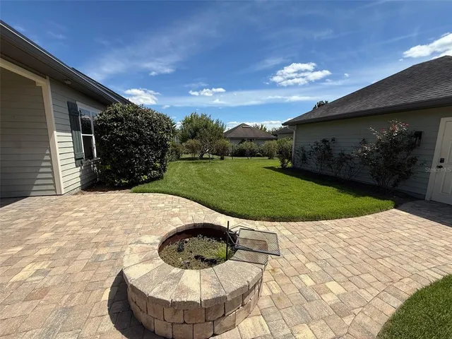 a view of a backyard with a garden and entertaining space