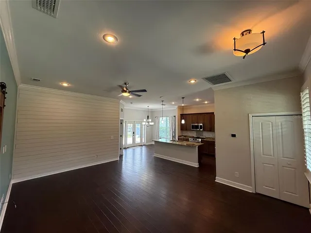a view of kitchen with refrigerator microwave and stove