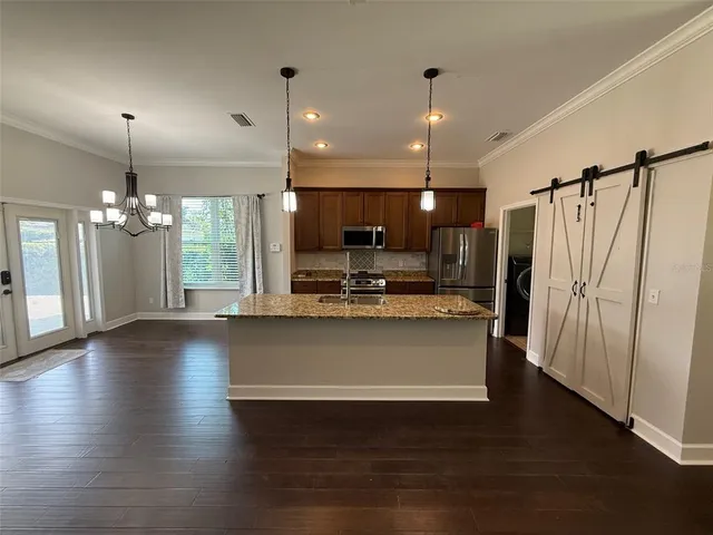 a view of kitchen with sink microwave and refrigerator