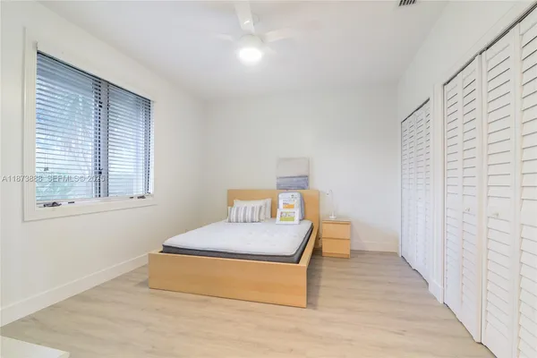 a bedroom with a bed and window