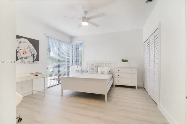 a large white room with a window and a couch