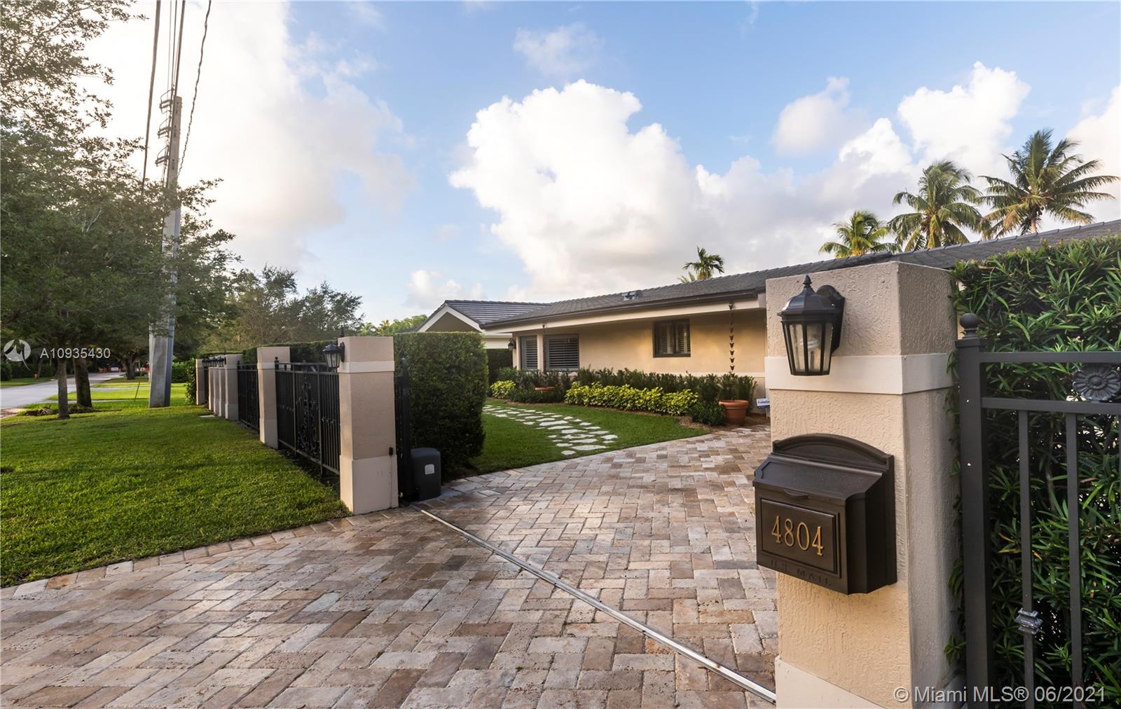 4804 Biltmore Drive Coral Gables, FL 33146 - Photo 2 of 47 a front view of a house with garden and patio