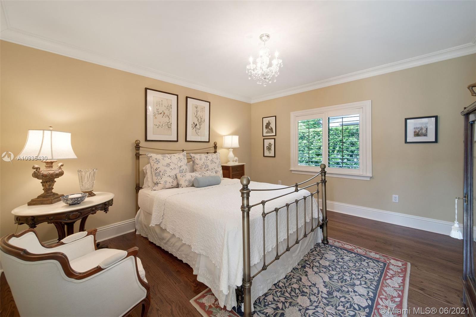 4804 Biltmore Drive Coral Gables, FL 33146 - Photo 17 of 47 a bed sitting in a bedroom next to a window