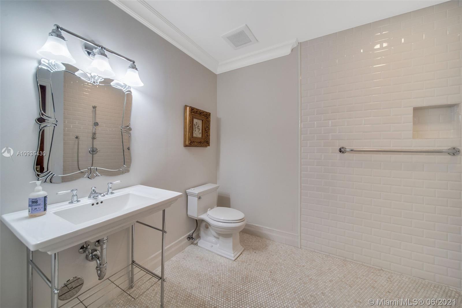 4804 Biltmore Drive Coral Gables, FL 33146 - Photo 26 of 47 a bathroom with a sink mirror and toilet