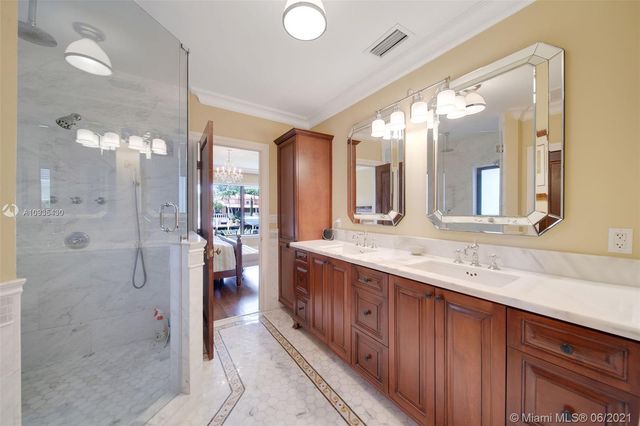 a bathroom with a granite countertop sink mirror and shower