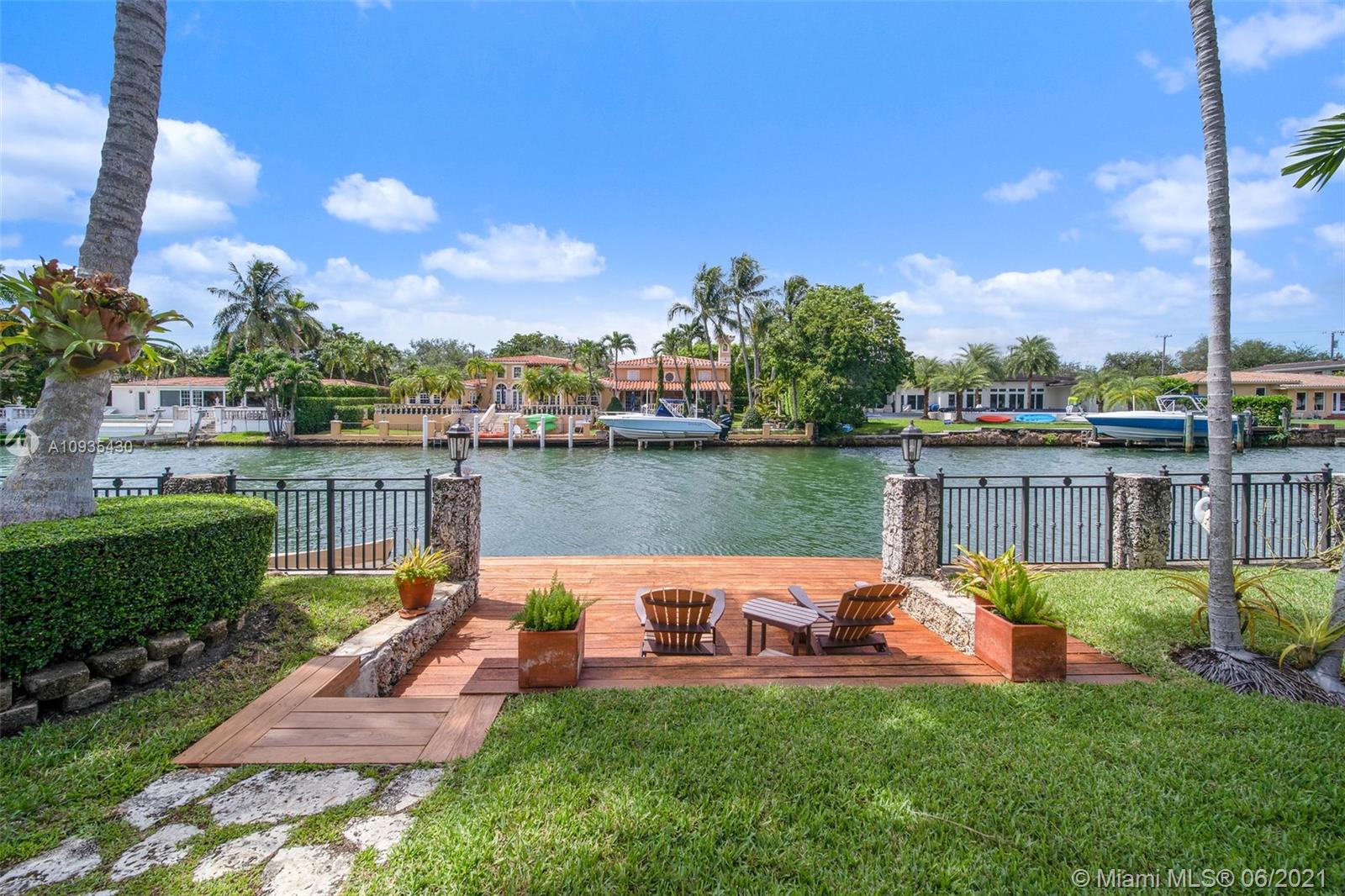 4804 Biltmore Drive Coral Gables, FL 33146 - Photo 41 of 47 a view of a swimming pool and lounge chairs in back yard of the house
