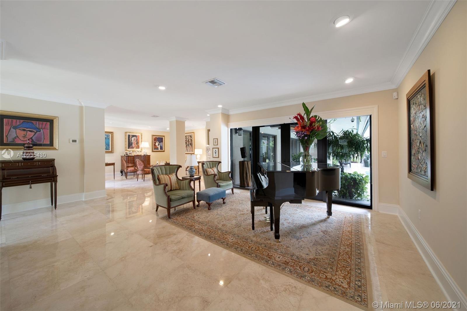4804 Biltmore Drive Coral Gables, FL 33146 - Photo 6 of 47 a living room with furniture a flat screen tv and a table
